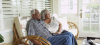 Mature black couple sitting on couch looking away