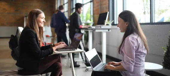 Two women working in an open-concept office