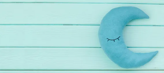 Moon pillow for bed on a blue background