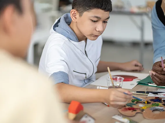 a young boy doing arts and crafts