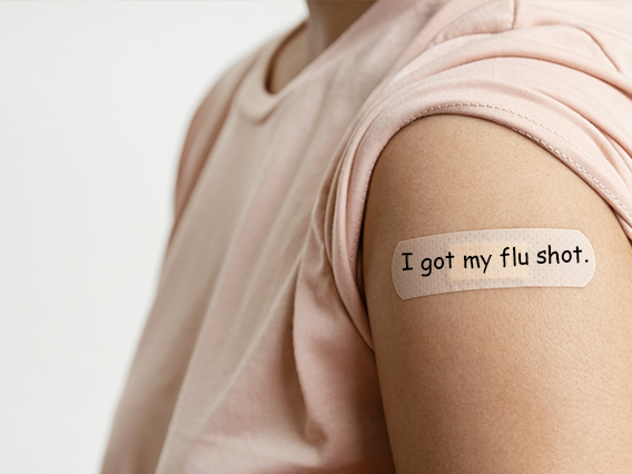 An arm with a rolled up sleeve, Band-Aid that says I got my flu shot