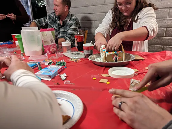 Wellness Ambassadors from EMSC building gingerbread houses before winter break.