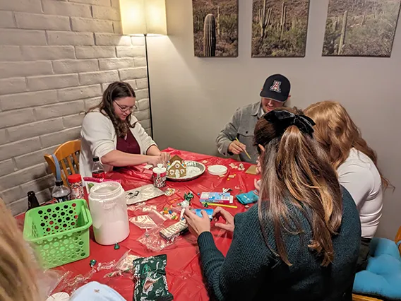 Wellness Ambassadors from EMSC building gingerbread houses before winter break.