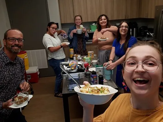 Colleagues in the kitchen eating baked potatoes