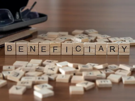 Wooden tiles that spell out beneficiary