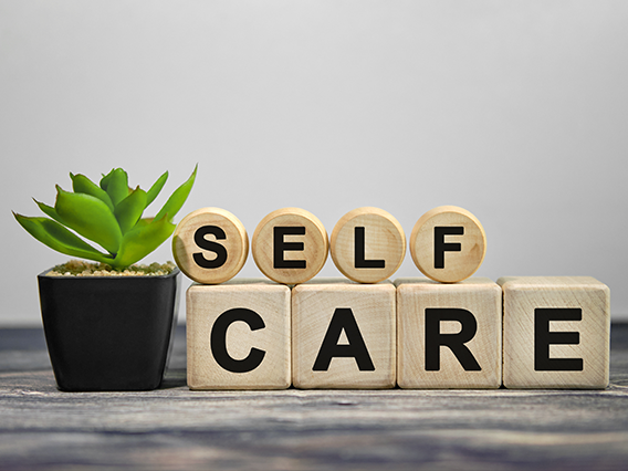 A succulent next to blocks spelling out Self Care
