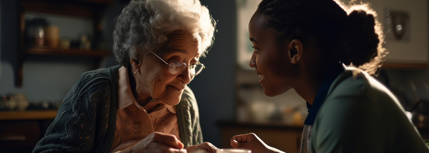 An elderly woman looking over at a younger African American woman