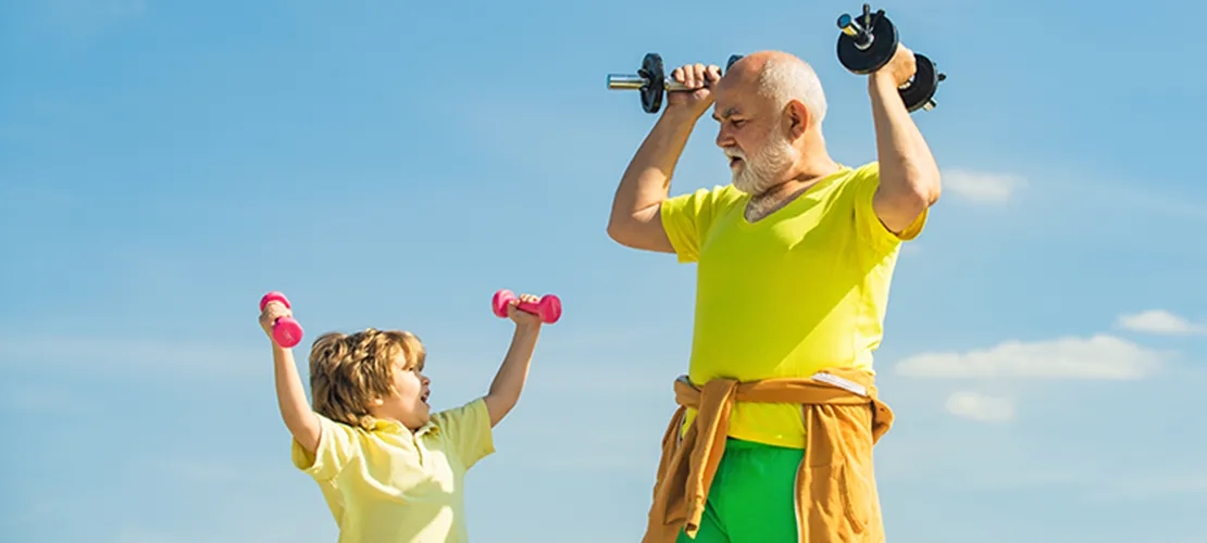 an older man and a young bow using hand weights