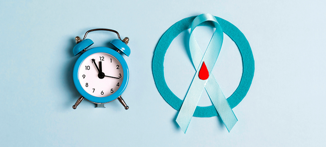 Alarm clock and prevent diabetes ribbon on a blue background