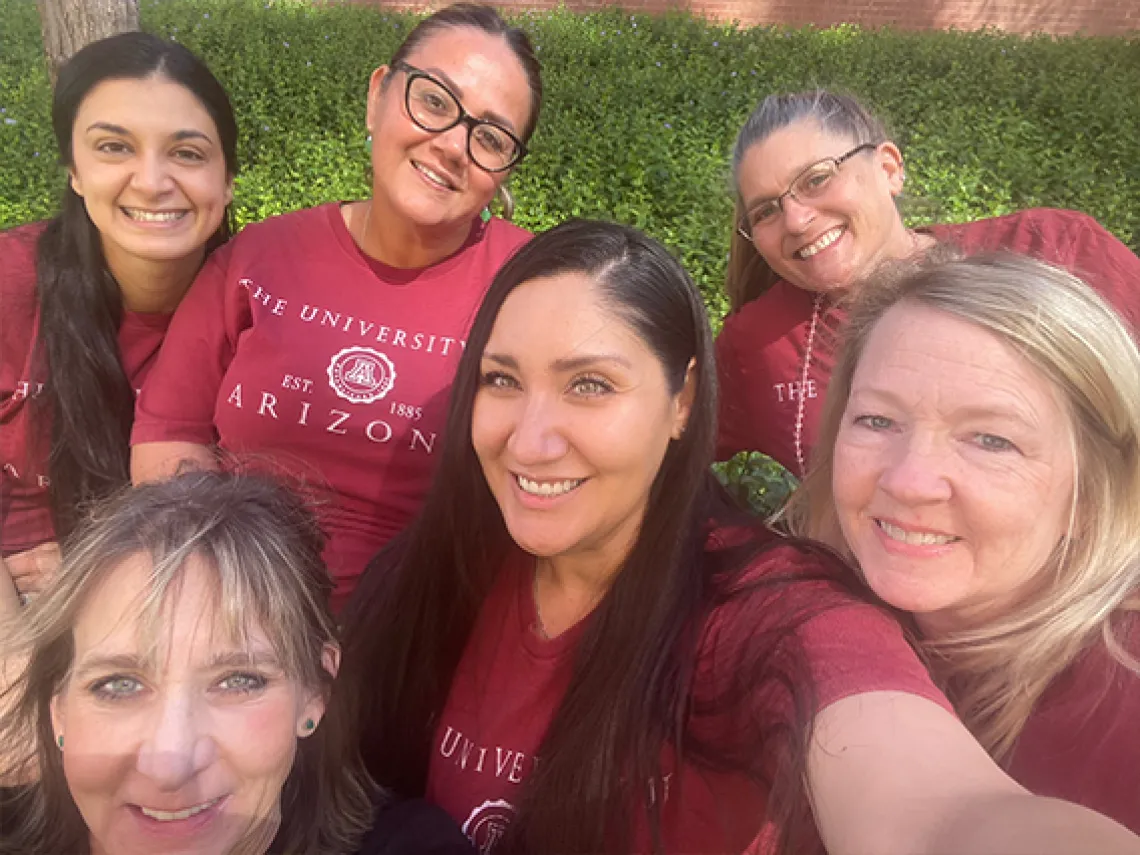 A group of women clustered together for a photo