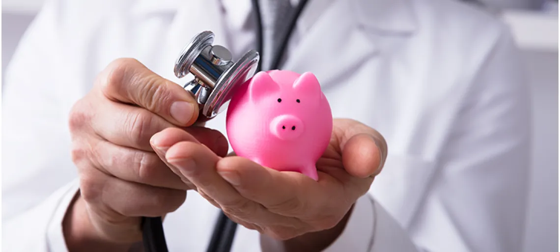 Doctor Checking Piggybank With Stethoscope