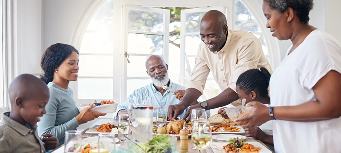 black family in home for a celebration, festive holiday and brunch.