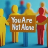 Colorful paper cutout figures holding hands with one highlighted in orange displaying 'You Are Not Alone' message, representing community support and connection.