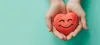 Holding a heart with a happy smiling face on a pale green background